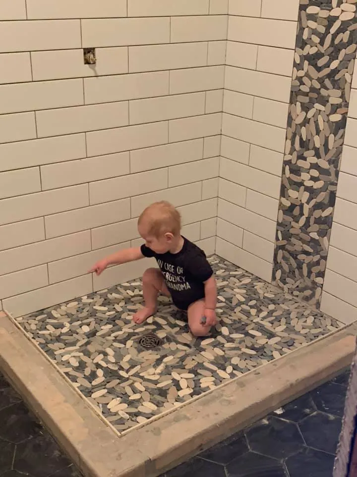 the family helping out on a bathroom shower tile job